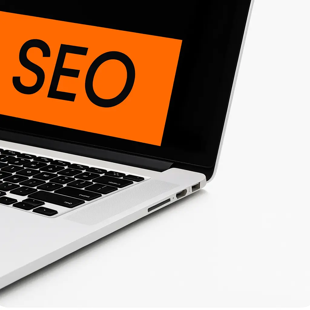 Modern laptop displaying SEO in bold orange text on screen, matching brand colors, with white background